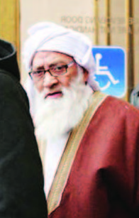 Flanked by supporters Mohammad Abdullah Saleem, the founder of the Islamic Institute of Education boarding school, leaves the Circuit Court of Cook County on Feb. 17.