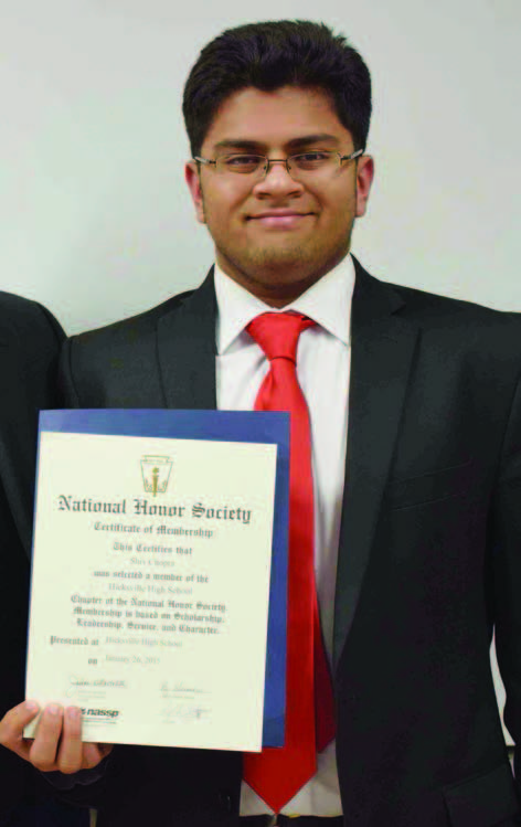 Shiv displaying the membership certificate