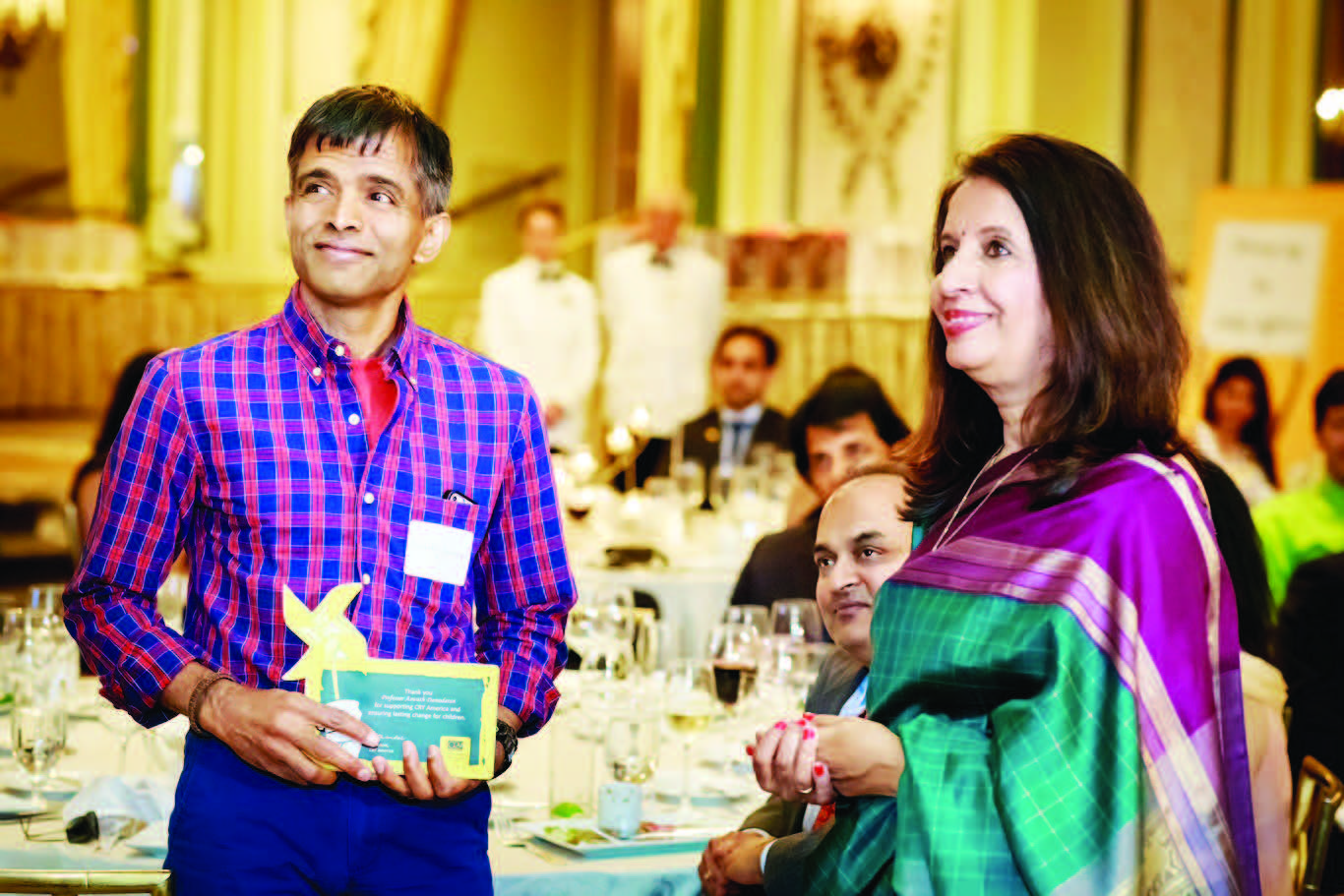 Ambassador Nirupama Rao presents a plaque to Professor Damodaran during the CRY Pledge 2015 Gala Dinner at The Taj Pierre in New York.