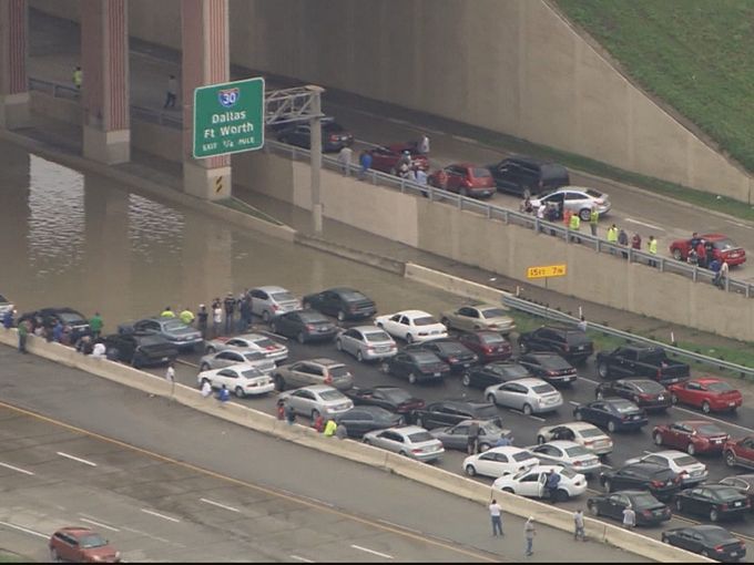 Flood waters submerged Texas highways and threatened more homes Friday, May 29 when a squall line stalled over Dallas overnight Thursday, dropping record-setting rainfall and triggering a Flash Flood Emergency