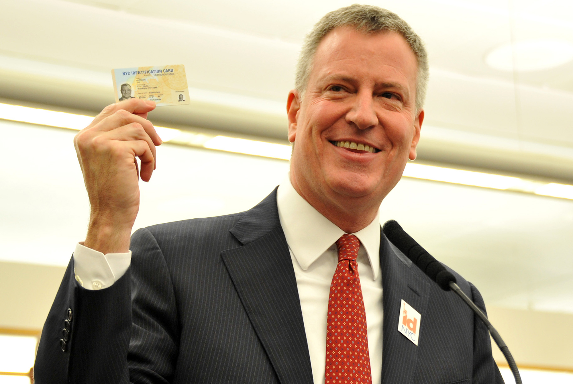NYC Mayor Bill de Blasio displays his IDNYC Card at the launch of the ambitious project of providing City ID to all residents