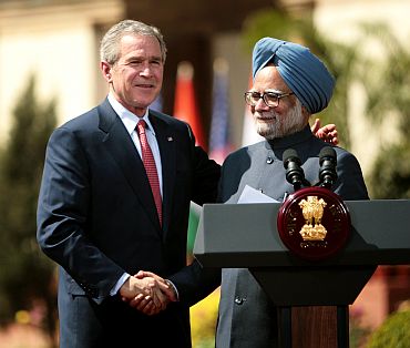 India's Prime Minister Dr. Manmohan Singh and US President George Bush shake hands after India and the United States sealed a civilian nuclear cooperation pact, in New Delhi