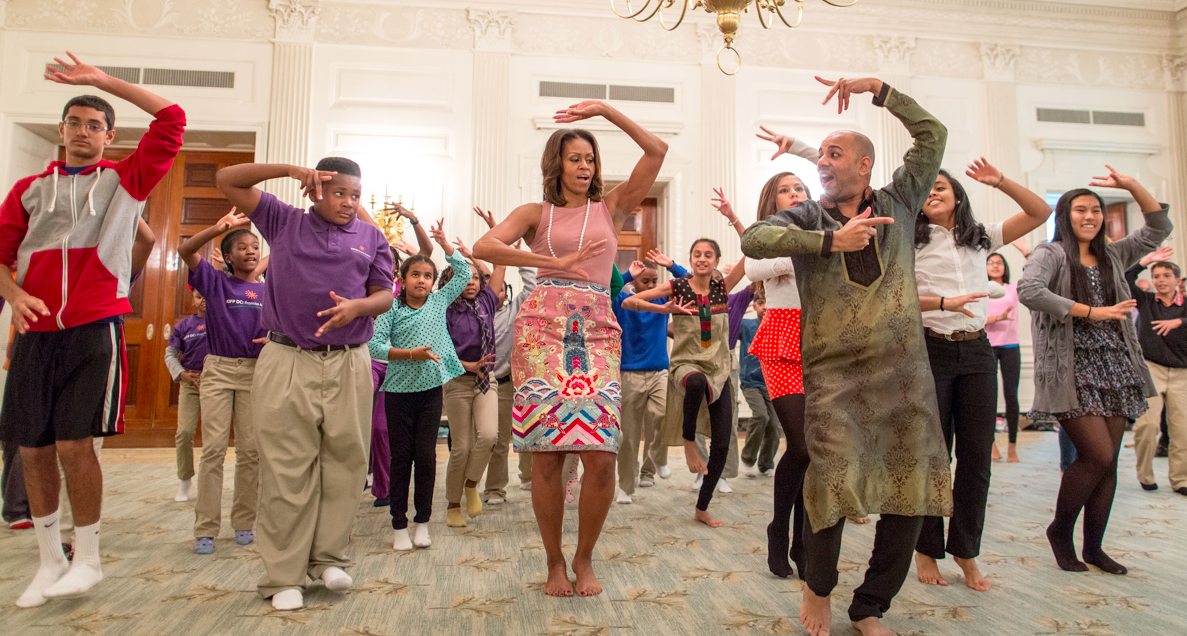 Michelle Obama tries out traditional dance moves, led by Nakul Dev Mahajan, a choreographer of the TV show So You Think You Can Dance.