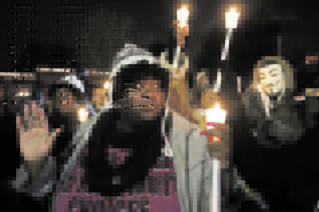 "Racial, gender and income inequalities are still factors that prove to be obstacles to substantive social justice." This Reuter photo shows people holding a protest demonstration outside Ferguson Police Department.