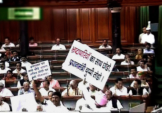Opposition MPs stormed the Well of the House, holding placards and shouting slogans in Lok Sabha on Monday, Aug 3, 2015, provoking the Speaker Sumitra Mahajan to suspend 25 Congress MPs for five days Photo courtesy PTI