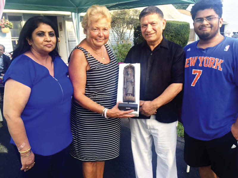 Hicksville legislator in Nassau County Rose Walker visited the Chopras and greeted them. She is flanked by the new citizens, Renu (left), Praveen and Shiv (right)