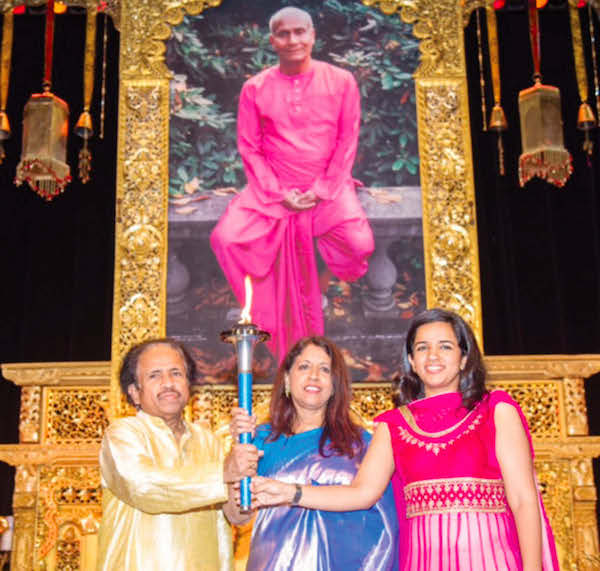 Kavita Krishnamurthy (Centre) holding Peace Torch with Dr L. Subramaniyam and their daughter Bindu at the Concert hall