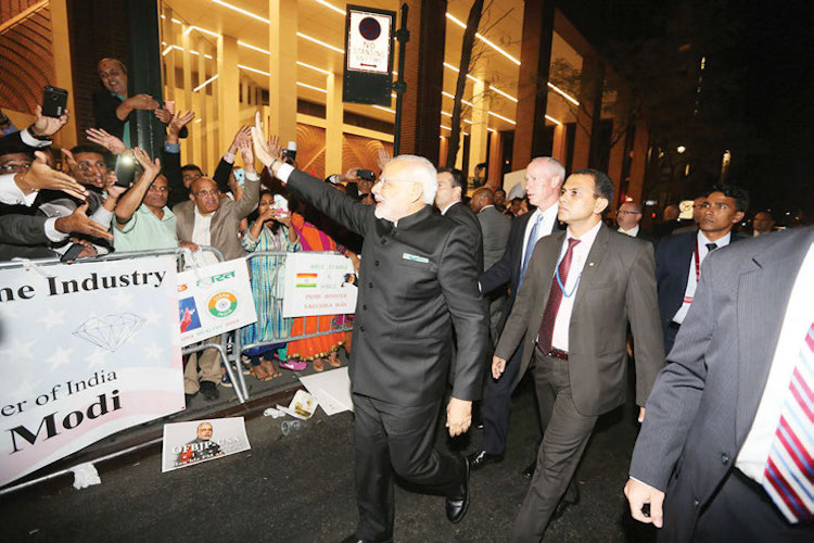 PM Modi waves to the Jubilant Indian Americans to welcome him at Hotel Waldorf Astoria, September 23 | Photo/ Mohammed Jaffer-SnapsIndia