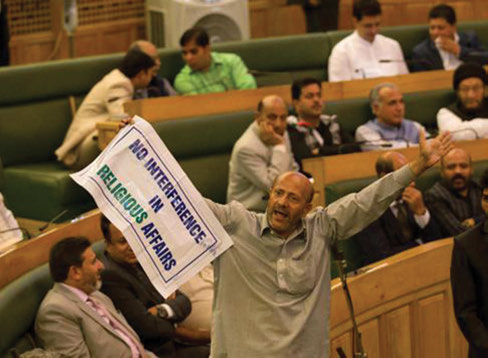 Engineer Rashid, an Independent MLA, holds a banner as he disrupts the first day of the Jammu and Kashmir assembly session in Srinagar.