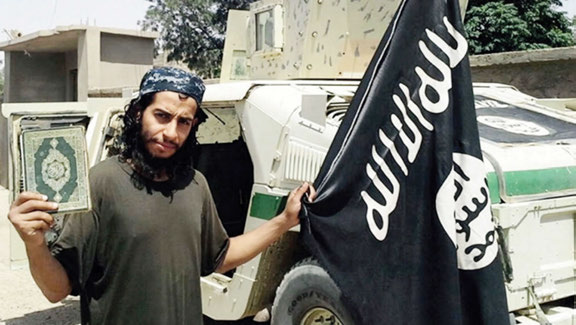 Abdel-hamid Abaaoud holding the Quran & the ISIS Flag