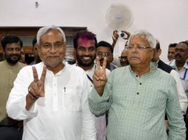 Kumar, a leader of Janata Dal (United) and Chief Minister of eastern state of Bihar, and Lalu Prasad Yadav, chief of Rashtriya Janata Dal, gesture after addressing a news conference in Patna