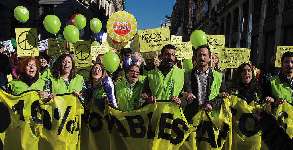 Greenpeace activists, demanding 100% renewable energy at Climate March 2015 in Madrid.