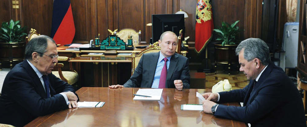 Photo caption:Russian President Vladimir Putin (C) meets Defense Minister Sergei Shoigu (R) and Foreign Minister Sergei Lavrov (L). Putin ordered the defense ministry to begin the withdrawal of Russian forces from Syria. (AFP)