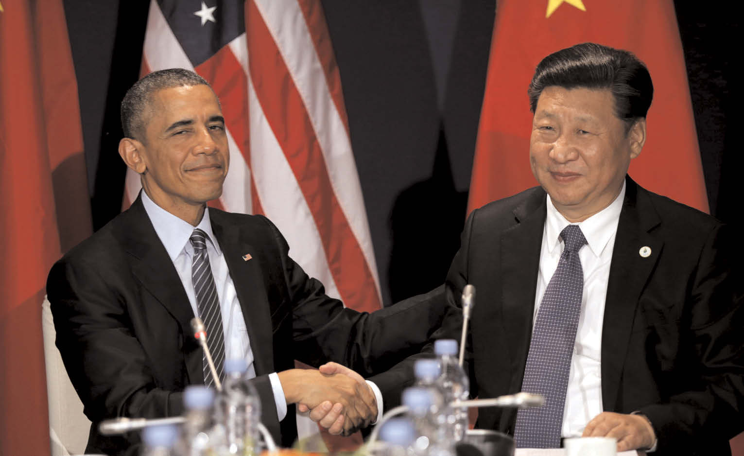 U.S. President Barack Obama shakes hands with Chinese President Xi Jinping during their meeting at the start of the climate summit in Paris last year (File photo)