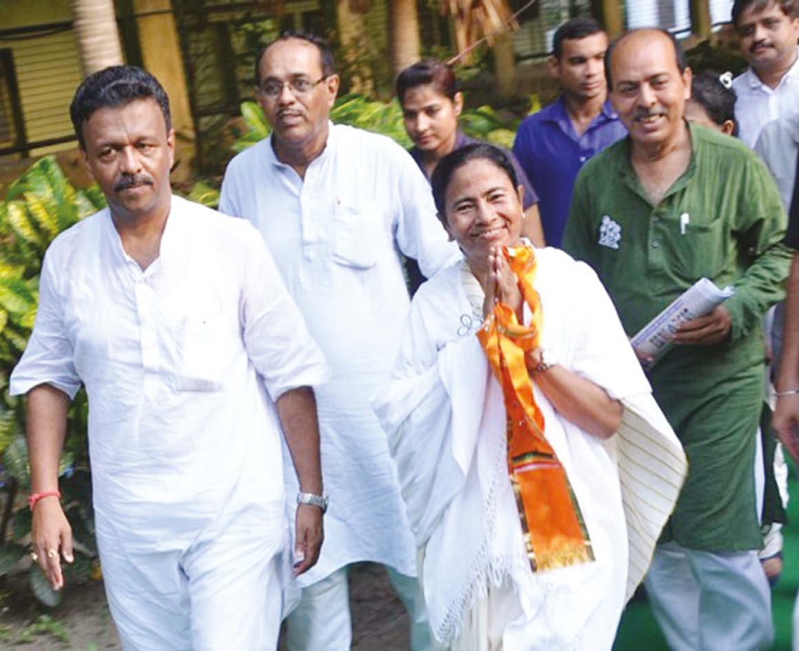 TMC chief Mamata Banerjee was sworn in as Chief Minister of West Bengal on Friday, May 27. Here she is seen with her party men during election campaign ~ File photo