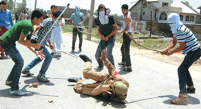 An Indian soldier being beaten with sticks by goons in Kashmir