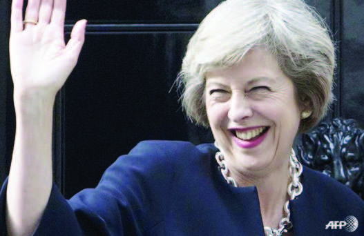 Britain's new Prime Minister Theresa May waves outside 10 Downing Street in central London on Jul 13, 2016, the day she takes office following the formal resignation of David Cameron.