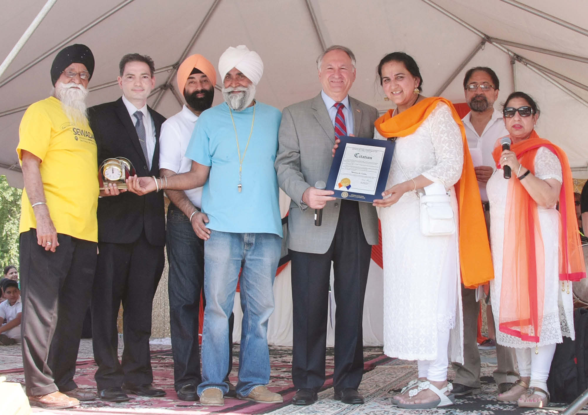 Mr. George Maragos, Nassau County Comptroller presents Nassau County Citation to Vaisakhi Mela organizers. Also seen in the picture is Mr. Dilip Chauhan, Director in the office of the Comptroller