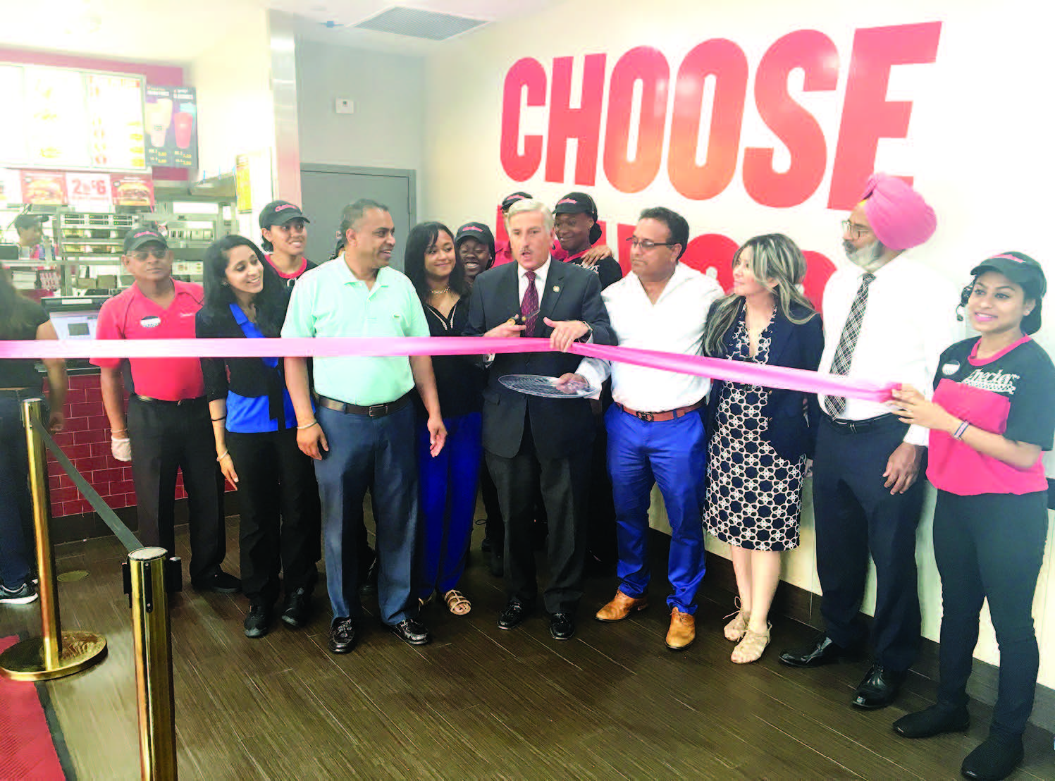 Checkers Grand Opening: Assemblyman David Weprin, partners Bhupider Singh and Manjit Singh, General Manager Monica Singh, and staff members at the grand opening of Checkers