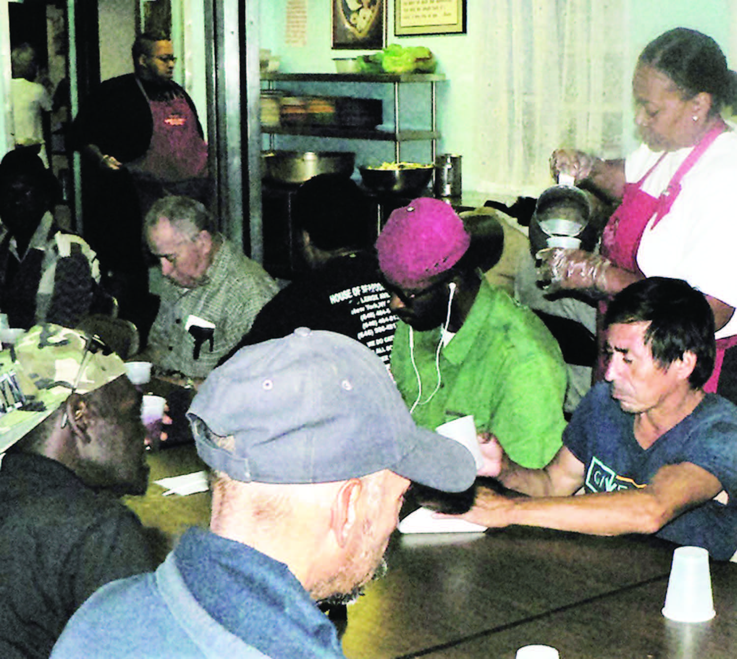 Police Captain Rachel Evans, volunteers to serve food to the poor at a facility run by Mother Teresa's sisters in New York's South Bronx