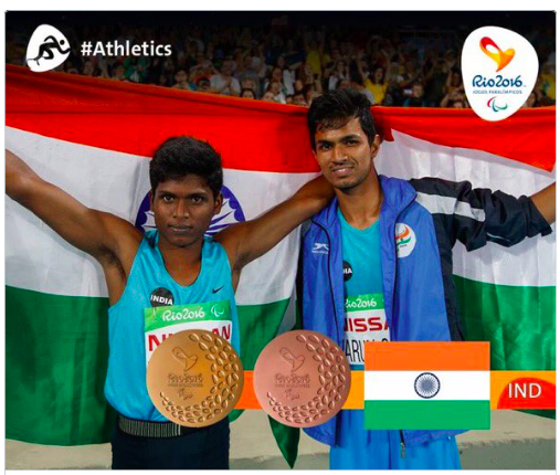 India's Mariyappan Thangavelu and Bhati Varun Singh celebrate their gold and bronze medals. AFP