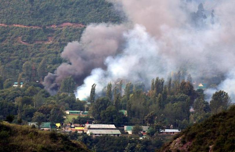 IMAGE: Smoke rises from the Uri Brigade camp during the September 18, 2016 terror attack. Photograph: Umar Ganie