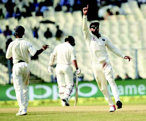 Virat Kohli and his teammates celebrating the wicket of Latham of New Zealand.