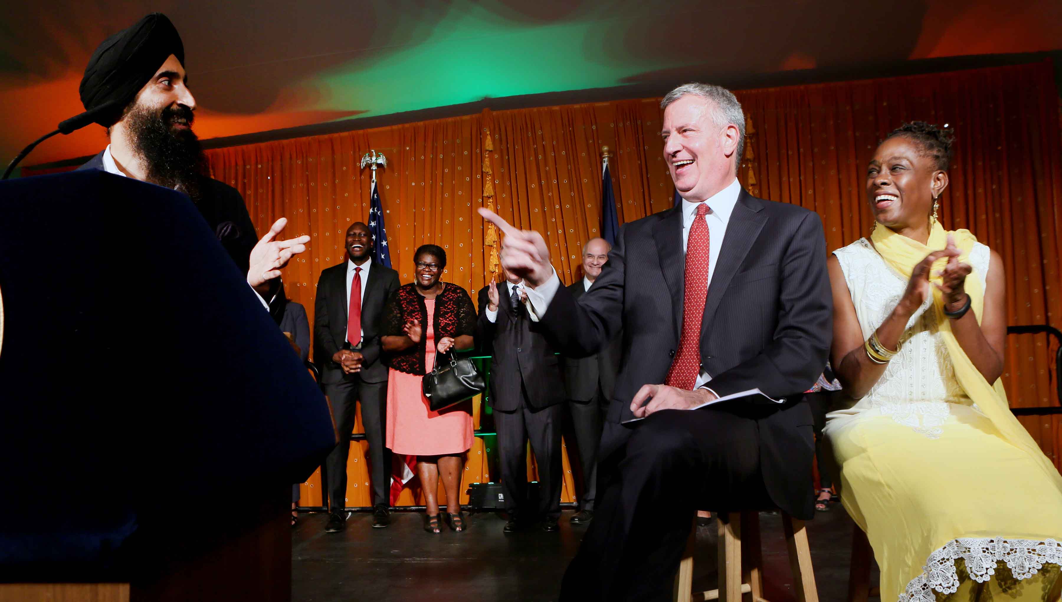 New York City Mayor Bill de Blasio and his wife Chirlane McCray (right), enjoy a lighter moment as Waris Ahluwalia (right), Actor, Designer, Model speaks on the occasion Photo/ Jay Mandal/On Assignment
