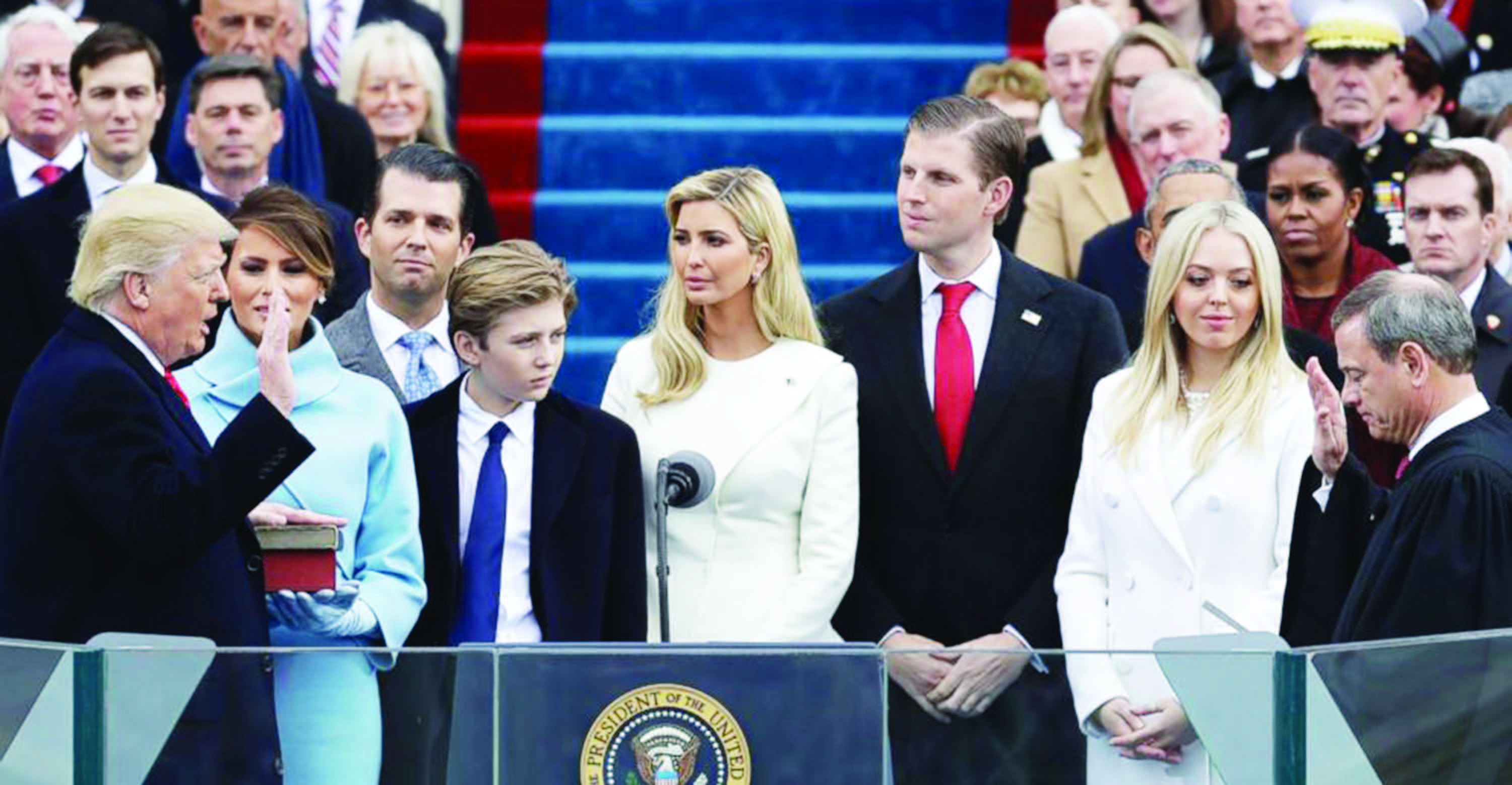 Supreme Court chief justice John Roberts administering the oath of office to Trump, with wife Melania holding the Bible and the Trump family in attendance