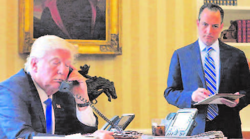 President Donald Trump speaks to Russia''s President Vladimir Putin at the White House, Washington. Chief of Staff Reince Priebus is seen standing (Right).