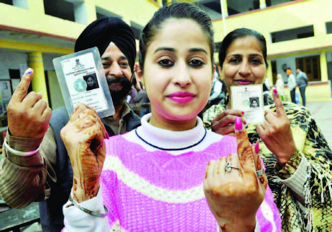 A girl, along with her family members, showing indelible ink mark on her finger after casting vote during the assembly election at a polling station in Patiala on February 4. Photo courtesy/ PTI