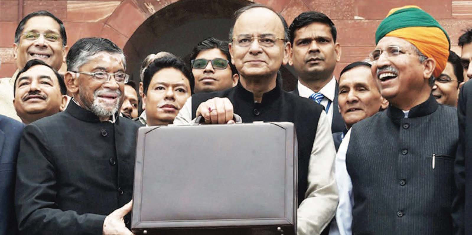 Finance Minister Arun Jaitley holding a briefcase of budget papers, with his colleagues and staff before going in to the Parliament to present the budget