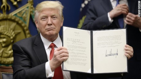 President Trump displays the travel ban order after signing it