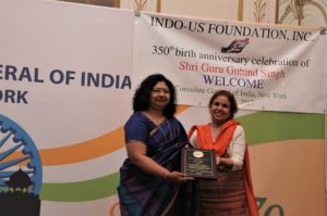 Dr. Nikky Guninder Kaur Singh presented a plaque to Air India Regional Manager USA Vandana Sharma