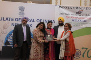 Dr. Nikky Guninder Kaur Singh presented a plaque to Mrs. and Jatinder Singh Bakshi of Singh & Singh Distribution. Dr. Hetal Gor is seen to the right of Dr. Singh