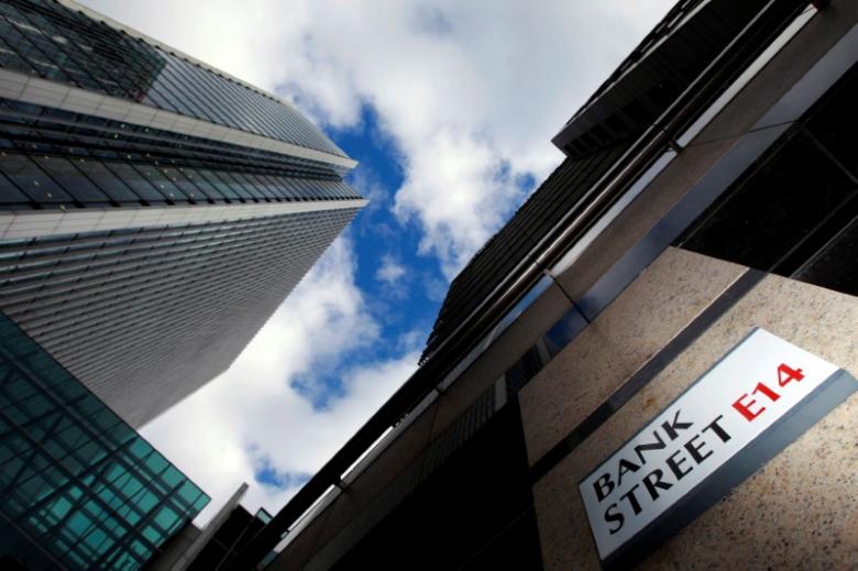 A sign for Bank Street and high rise offices are seen in the financial district in Canary Wharf in London, Britain, October 21, 2010. REUTERS/Luke Macgregor/File Photo