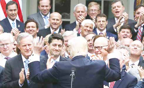 A jubilant Donald Trump congratulates House Republicans after they passed legislation aimed at repealing and replacing Obamacare, during an event in the Rose Garden at the White House, on May 4, 2017 in Washington, DC.