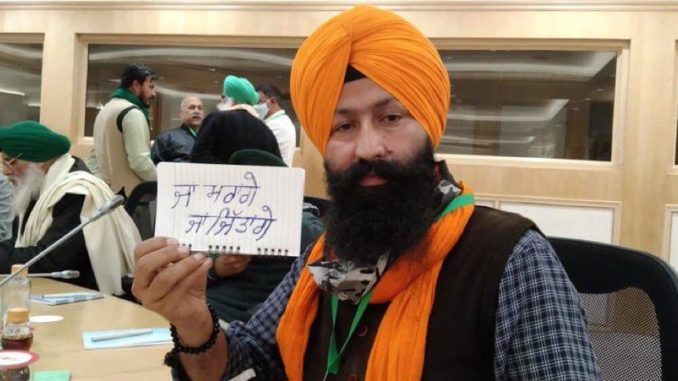A farmer at the meeting displays the resolve of farmers Either will win or die