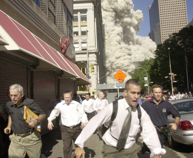 People run for life after the World Trade Center Twin Towers were struck